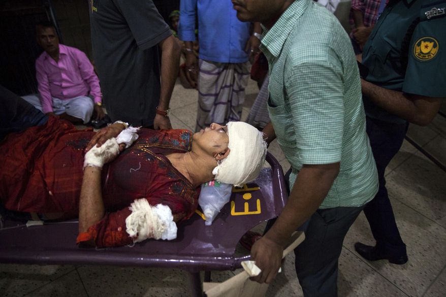 In this Thursday, Feb. 26, 2015, photo , Rafida Ahmed, wife of a prominent Bangladeshi-American blogger, Avijit Raoy is being rushed to hospital on a stretcher after she was seriously injured by unidentified attackers, in Dhaka, Bangladesh. Roy, who was known for speaking out against religious fundamentalism was hacked to death in the streets of Bangladesh's capital as he walked with his wife, police said Friday. (AP Photo/Rajib Dhar)