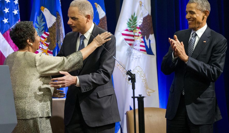 Singer Aretha Franklin, left, hugs outgoing Attorney General Eric Holder, as President Barack Obama applauds, at an event celebrating Holder at the Department of Justice in Washington, Friday, Feb. 27, 2015. Franklin (AP Photo/Jacquelyn Martin)