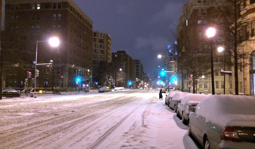 Early morning streets are quiet Feb. 17, 2015, in Washington. Tens of thousands of people in the mid-Atlantic region stayed home Tuesday as government offices shut down following a winter storm. Roads and sidewalks in the nation&#39;s capital looked desolate as Mayor Muriel Bowser declared a snow emergency. (Associated Press)