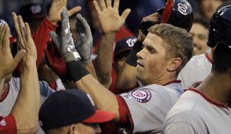 Washington Nationals&#39; Tyler Moore is cheered in the dugout after hitting a home run in the third inning of a baseball game against the Philadelphia Phillies, Friday, May 2, 2014, in Philadelphia. (AP Photo/Laurence Kesterson)
