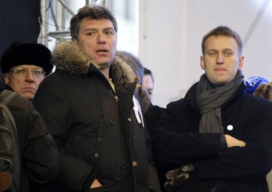 FILE  - In this file photo taken on Saturday, Dec.  24, 2011, From left, Russian former Financial Minister Alexei Kudrin, leaders of the opposition Boris Nemtsov and Alexei Navalny attend a rally to protest against alleged vote rigging in Russia&#39;s parliamentary elections on Sakharov avenue in Moscow, Russia. Russia&#39;s Interior Ministry says Boris Nemtsov, a leading opposition figure and former deputy prime minister, has been shot and killed near the Kremlin. Nemtsov, a sharp critic of President Vladimir Putin, was killed early Saturday. His death comes just a day before a major opposition rally in Moscow. (AP Photo/Misha Japaridze)