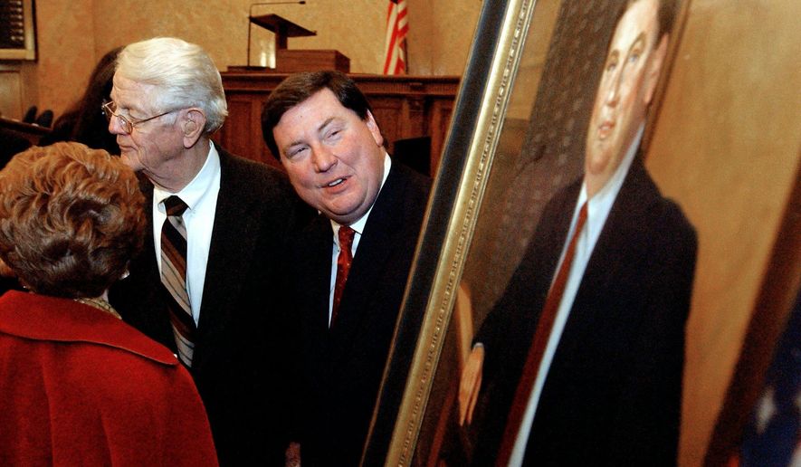 File-This Dec. 11, 2003, file photo shows retiring Mississippi House Speaker Tim Ford, right, sneaking a peek at his likeness as he speaks with Ken and Mary Foose of Jackson, Miss., following ceremonies honoring Ford&#39;s tenure in Jackson.  Ford, a former speaker of the Mississippi House, died Friday, Feb. 27, 2015,  at his home in Oxford. He was 63. Ben Stone, one of Ford’s partners at the Balch &amp;amp; Bingham law firm, confirmed Ford died of a heart attack Friday evening in Oxford.  (AP Photo/Rogelio Solis, File)