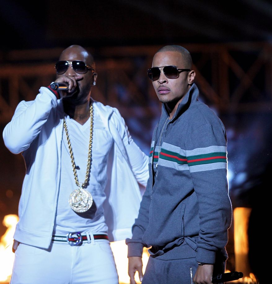 File-This Oct. 1, 2011, fi;e photo shows Rapper T.I., right, and Young Jeezy, left, performing during the BET Hip Hop Awards in Atlanta. Two people suffered non-life-threatening injuries after being shot Saturday, Feb. 28, 2015, at a Charlotte nightclub where rappers T.I., Young Jeezy and Yo Gotti were advertised to appear, a Charlotte-Mecklenburg police spokesman said. USA Today is reporting all three rappers were on stage during the shooting.(AP Photo/David Goldman, File)
