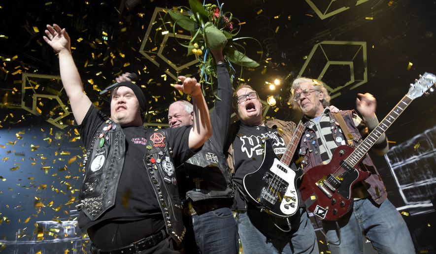 In this photo taken on Saturday, Feb. 28, 2015, punk band Pertti Kurikan Nimipäivät (PKN) celebrate after being selected to represent Finland's in the Eurovision song contest, during Yle's New Music Competition, in Helsinki. Four punk rockers with learning disabilities will compete for Finland in the Eurovision Song Contest semifinal after winning the Nordic country's national qualifying contest. The group Pertti Kurikan Nimipaivat, or PKN, was formed in 2009 at a workshop organized by an association that provides support for people with disabilities. The members have diagnoses such as autism and Down syndrome. (AP Photo/Lehtikuva, Markku Ulander) FINLAND OUT