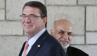 Afghan President Ashraf Ghani (right) is courting a longer stay by U.S. troops, whom he thanks for their sacrifices. Last month, he stood shoulder to shoulder at the presidential palace with Defense Secretary Ashton Carter. (Associated Press)