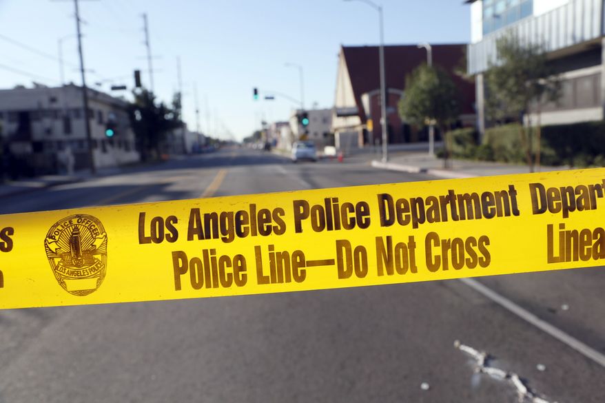 Police crime scene tape is stretched across a street in South Central Los Angeles. (Associated Press) **FILE**