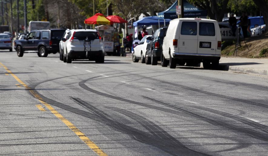 Skid marks are visible along Plummer Street in the Chatsworth section of Los Angeles following an illegal street racing crash that killed two bystanders. (Associated Press)