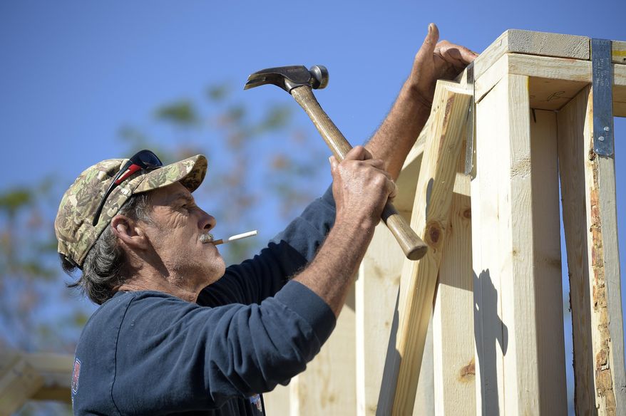 In this Feb. 13, 2015 photo, construction worker David Rager, 53, frames the upper floor of a two-story custom home being built in Orlando, Fla. As construction jobs return in some regions, competition for skilled labor is heating up.(AP Photo/Phelan M. Ebenhack)