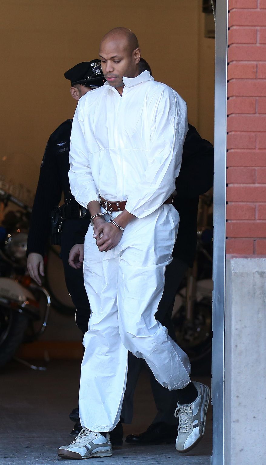 Radnor Township Police lead Sean Moses out to a waiting police van in Radnor, Pa. on Monday, March 2, 2015. The suburban Philadelphia man sneaking around on his hands and knees videotaped naked young women and girls in dressing rooms at one of the country's largest malls and then posted the clips on online pornography websites, police said Monday. (AP Photo/Philadelphia Daily News, David Maialetti) THE EVENING BULLETIN, TV OUT, MAGS OUT, NO SALES