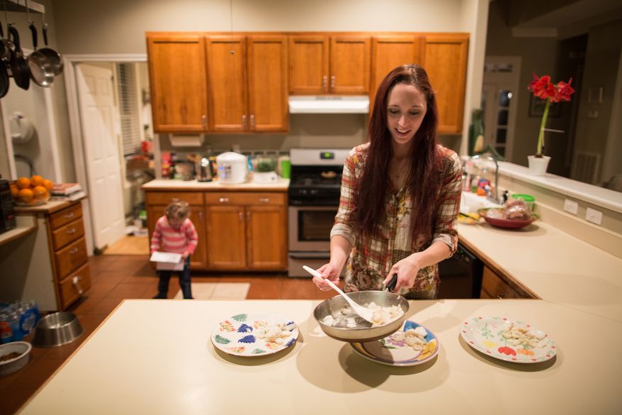 Maggie Barcellano prepares dinner at her father's house in Austin, Texas on Saturday, Jan. 25, 2014. Ms. Barcellano, who lives with her father, enrolled in the food stamps program to help save up for paramedic training while she works as a home health aide and raises her 3-year-old daughter. Working-age people now make up the majority in U.S. households that rely on food stamps, a switch from a few years ago when children and the elderly were the main recipients. (AP Photo/Tamir Kalifa)