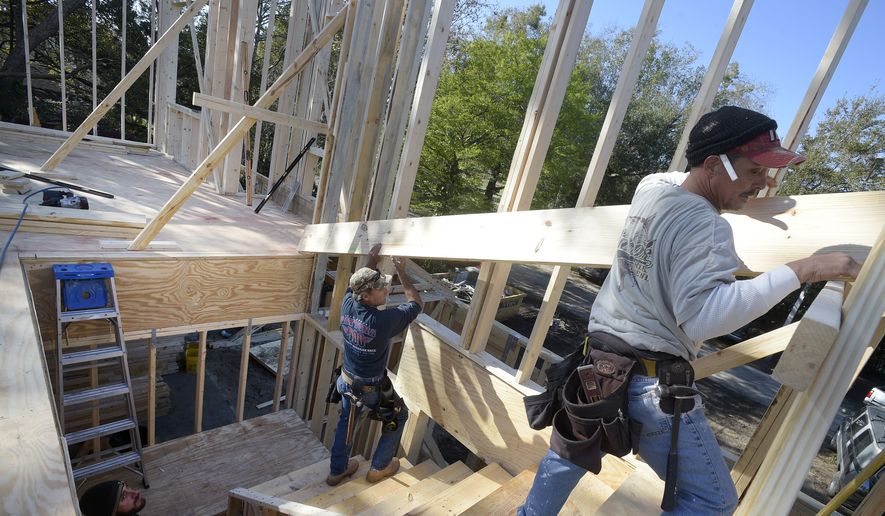 In this Feb. 13, 2015 photo, construction workers James Gibson, left, David Rager, center, and Shawn White frame the second floor of a two-story custom home being built in Orlando, Fla. As construction jobs return in some regions, competition for skilled labor is heating up. (AP Photo/Phelan M. Ebenhack) ** FILE **