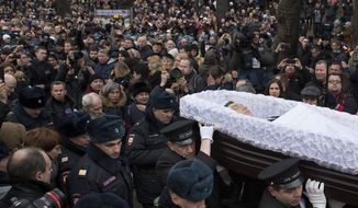 People follow the coffin of Boris Nemtsov during a farewell ceremony at the Sakharov center in Moscow, Russia, Tuesday, March 3, 2015. (AP Photo/Pavel Golovkin)
