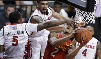Rutgers guard Mike Williams tries to block a shot by Maryland guard Melo Trimble (2) during the first half of an NCAA college basketball game Tuesday, March 3, 2015, in Piscataway, N.J. (AP Photo/Mel Evans)