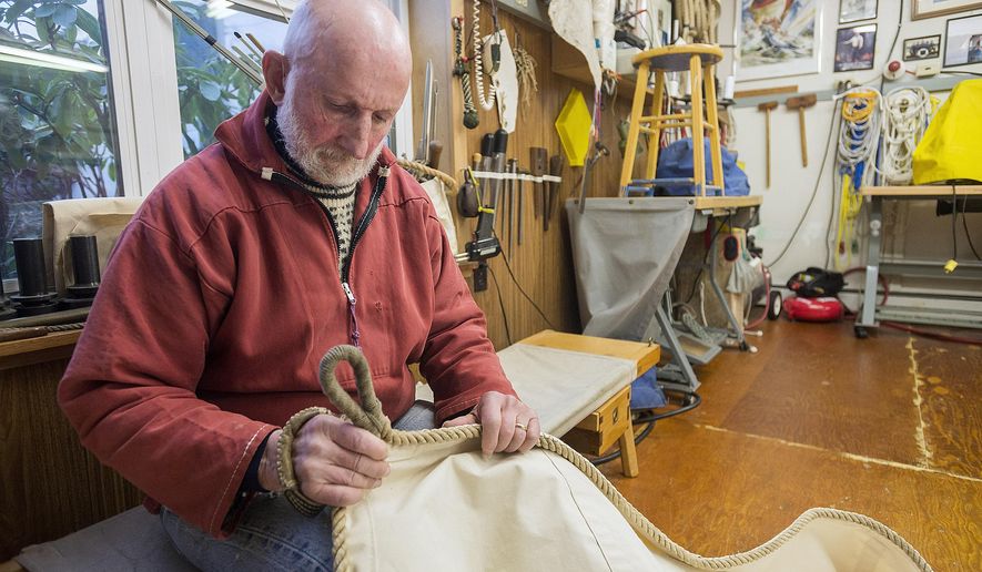 ADVANCE FOR SUNDAY MARCH 8 AND THEREAFTER In this Feb. 25, 2015 photo, sailmaker Louie Bartos examines one of his sails in his workshop in Ketchikan, Alaska. Bartos will make a replica sail for a restored Bristol Bay double-ender boat that will be displayed in the Alaska State Museum. (AP Photo/Ketchikan Daily News, Taylor Balkom)