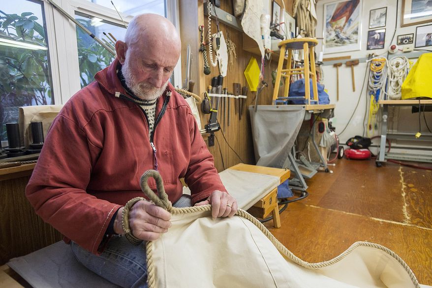 ADVANCE FOR SUNDAY MARCH 8 AND THEREAFTER In this Feb. 25, 2015 photo, sailmaker Louie Bartos examines one of his sails in his workshop in Ketchikan, Alaska. Bartos will make a replica sail for a restored Bristol Bay double-ender boat that will be displayed in the Alaska State Museum. (AP Photo/Ketchikan Daily News, Taylor Balkom)