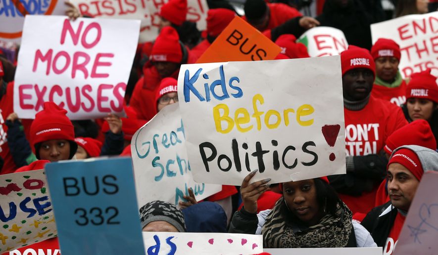 Charter school advocates hold signs as they rally outside the state Capitol on Wednesday, March 4, 2015, in Albany, N.Y. An estimated 13,000 students, teachers and parents rallied to support Gov. Andrew Cuomo&#x27;s call for more of the publicly funded, but privately run, schools. (AP Photo/Mike Groll)