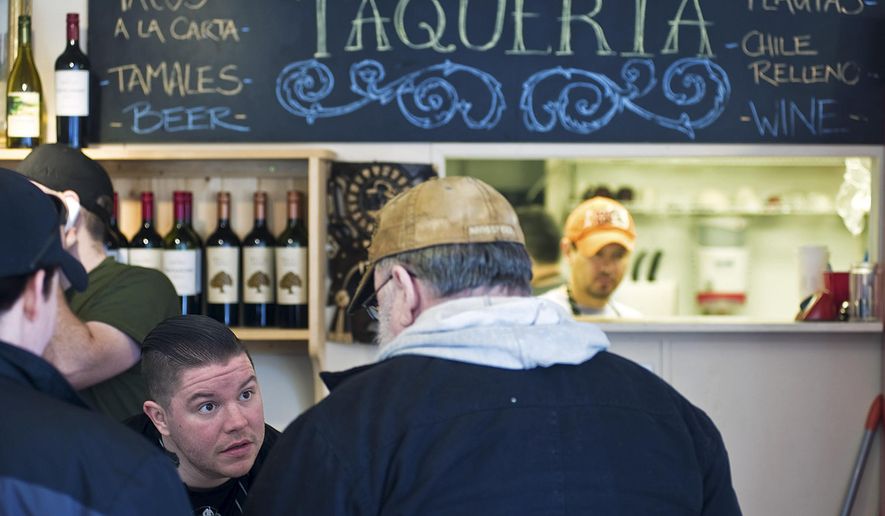 ADVANCE FOR SATURDAY MARCH 7 AND THEREAFTER In this Feb. 27, 2015 photo, chef Beau Schooler, left, takes orders at The Taqueria restaurant in Juneau, Alaska. How seasoned does a chef need to be to start a business or receive an award? Some might consider the culinary and entrepreneurial minds behind some of Juneau’s hippest restaurants green, but they’re ready to prove otherwise. (AP Photo/Juneau Empire, Michael Penn)