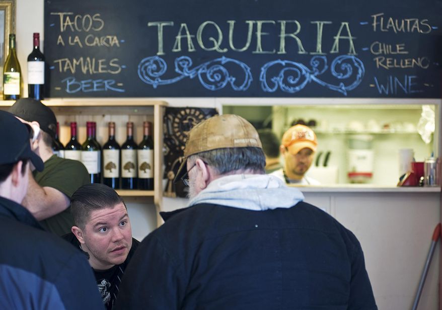 ADVANCE FOR SATURDAY MARCH 7 AND THEREAFTER In this Feb. 27, 2015 photo, chef Beau Schooler, left, takes orders at The Taqueria restaurant in Juneau, Alaska. How seasoned does a chef need to be to start a business or receive an award? Some might consider the culinary and entrepreneurial minds behind some of Juneau’s hippest restaurants green, but they’re ready to prove otherwise. (AP Photo/Juneau Empire, Michael Penn)