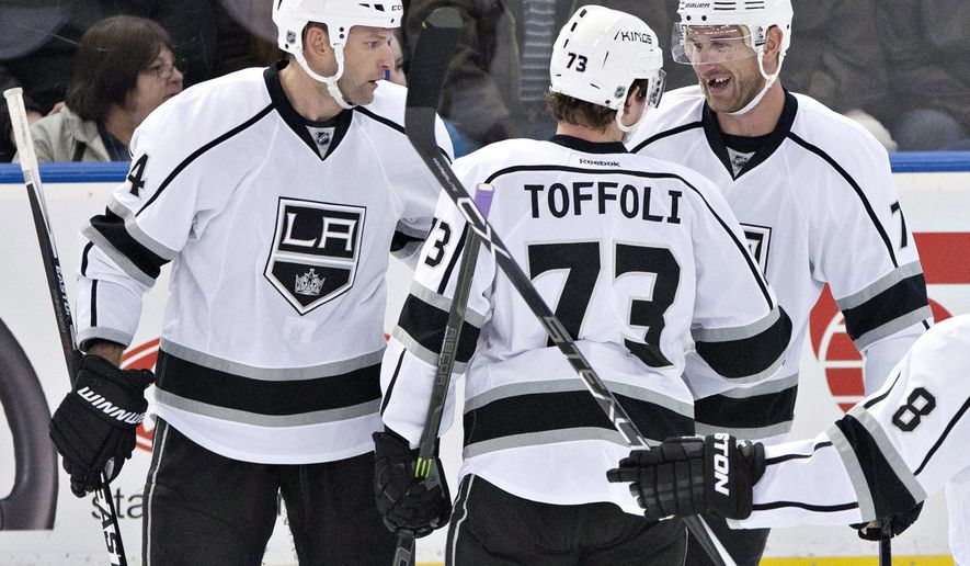 Los Angeles Kings&#39; Robyn Regehr (44), Tyler Toffoli (73) and Jeff Carter (77) celebrate a goal against the Edmonton Oilers during the second period of an NHL hockey game in Edmonton, Alberta, Tuesday, March 3, 2015. (AP Photo/The Canadian Press, Jason Franson)