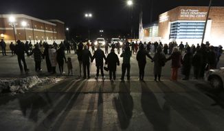 Protestors block traffic outside the Ferguson, Mo., police department, Wednesday, March 4, 2015, in Ferguson. (AP Photo/Charles Rex Arbogast) ** FILE **