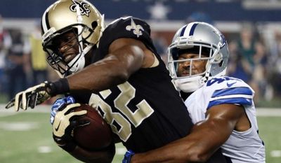 New Orleans Saints tight end Benjamin Watson (82) tries to break free from Dallas Cowboys free safety Barry Church (42) in Arlington, Texas, Sept. 28, 2014. (Associated Press) ** FILE **