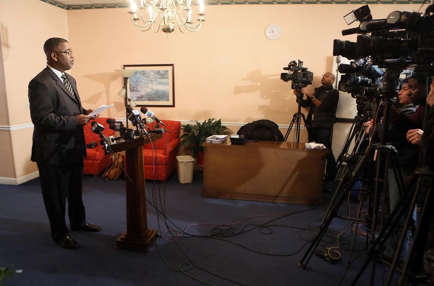 Funeral home spokesman Sean Howard makes a statement and takes questions from reporters at a press conference at the Smith, Bizzell, Warner and Sons Funeral Home, Thursday, March 5, 2015, in Gary, Ind. Howard said the remains of two mummified or skeletonized babies found inside small boxes above ceiling tiles at the funeral home in northwestern Indiana were placed there by an employee last fall and taken down the same day by the manager of the facility.  (AP Photo/The Times, John J. Watkins)  MANDATORY CREDIT; CHICAGO LOCALS OUT;  GARY OUT