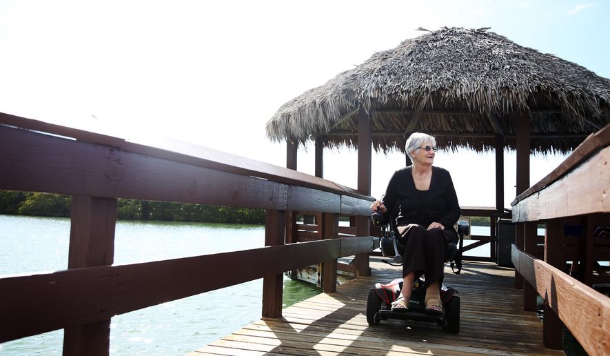 Lorraine Tredge takes a ride around her neighborhood on Feb. 22, 2015, in Naples, Fla. Tredge was diagnosed with Polio at 17 and rather than perceiving it at something to overcome, she invited new possibilities based on what life brought her. (AP Photo/Naples Daily News, Dania Maxwell) FORT MYERS OUT