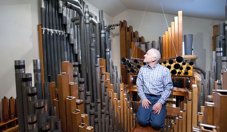 In a Friday, Oct.31, 2014 photo, Guy Vander Wagen sits in one of the two pipe rooms in a modest west side Grand Rapids, Mich. home. The former owner built a two-room addition the house so a 3200 pipe, wind powered pipe organ could be put inside. David Luttinen of Mountlake Terrace, Wa., hopes to move across the country so he can live in a Grand Rapids home containing a massive pipe organ. Luttinen says the church organ is the motivating factor for purchasing the bungalow. (AP Photo/The Grand Rapids Press, Chris Clark) ALL LOCAL TELEVISION OUT; LOCAL TELEVISION INTERNET OUT