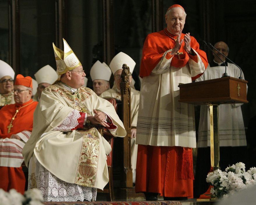 Cardinal Edward Egan, right, applauds Archbishop Timothy Dolan during Dolan's Mass of Installation Wednesday, April 15, 2009 at St. Patrick's Cathedral in New York. The former Milwaukee archbishop is taking over the most visible American job in the Roman Catholic Church and the nation's second-largest diocese after Los Angeles. (AP Photo/Julie Jacobson, Pool)