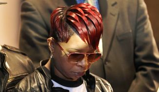 Lesley McSpadden, mother of Michael Brown Jr., listens to the family attorney during a news conference, Thursday, March 5, 2015, in Dellwood, Mo. Neither McSpadden nor Brown&#39;s father, Michael Brown Sr., spoke or took questions. (AP Photo/Charles Rex Arbogast)