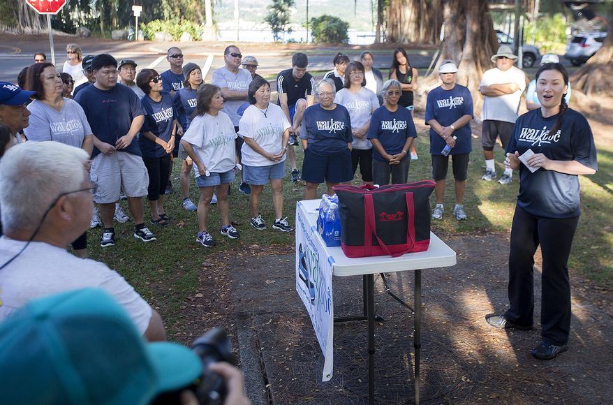 ADVANCE FOR SATURDAY MARCH & AND THEREAFTER In this March 1, 2015 photo, medical student Tara Reed, right, gives a talk about vitamin supplements during Walk with a Doc at Liliuokalani Park and Gardens in Hilo, Hawaii. Dr. Craig Kadooka and other health professionals in the Hilo area launched Walk With a Doc, a regular Sunday meeting at Liliuokalani Park and Gardens in Hilo. (AP Photo/Hawaii Tribune-Herald, Hollyn Johnson)