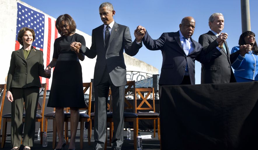 Former first lady Laura Bush, left, first lady Michelle Obama, President Barack Obama, Rep. John Lewis, D-Ga., former President George W. Bush, and Rep. Terri Sewell, D-Ala., hold hands during a prayer after the president&#x27;s speech by the Edmund Pettus Bridge in Selma, Ala., on the 50th anniversary of &amp;#8220;Bloody Sunday,&quot; a landmark event of the civil rights movement, Saturday, March 7, 2015. (AP Photo/Jacquelyn Martin)