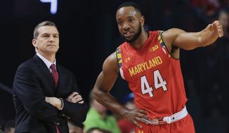 Maryland coach Mark Turgeon, left, and Maryland&#x27;s Dez Wells (44) talk on the sideline during the first half of an NCAA college basketball game against Nebraska in Lincoln, Neb., Sunday, March 8, 2015. (AP Photo/Nati Harnik)