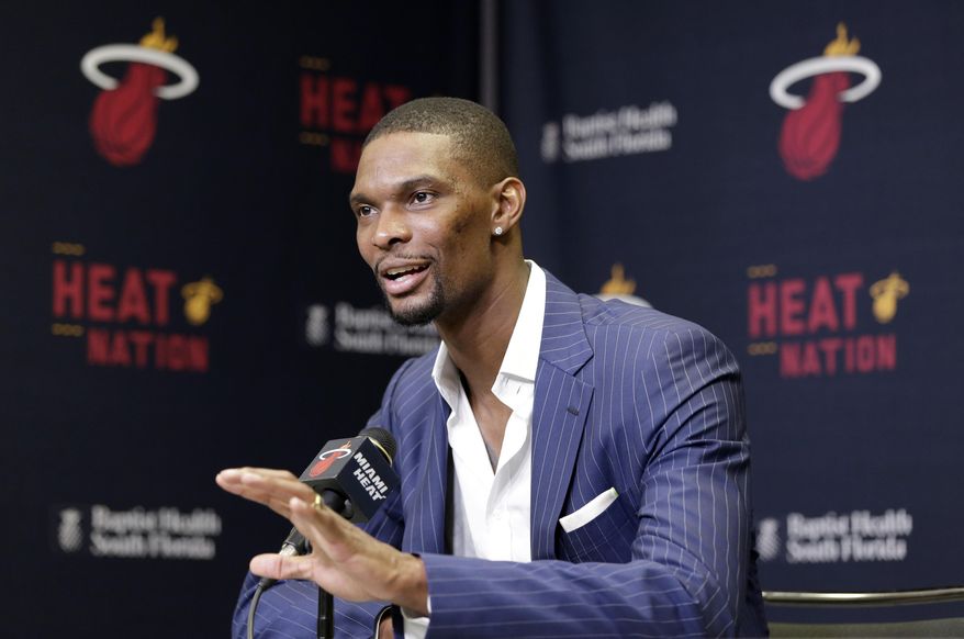 Miami Heat center Chris Bosh gestures as he speaks during a news conference before the start of an NBA basketball game between the Heat and the Boston Celtics, Monday, March 9, 2015, in Miami. Bosh is recovering after falling seriously ill because of blood clots on one of his lungs. The Heat said that Bosh is scheduled to resume &amp;quot;full basketball activities&amp;quot; in September. (AP Photo/Wilfredo Lee),