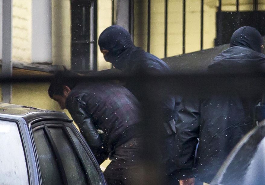 Police escorts Zaur Dadaev, believed to be one of five suspects in the killing of Boris Nemtsov, into a court room in Moscow, Russia, March 8, 2015. (AP Photo/Ivan Sekretarev) ** FILE **