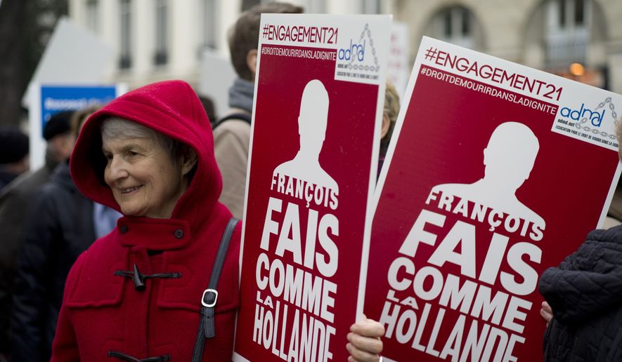 Pro-euthanasia demonstrators gather near the French National Assembly in Paris, Tuesday March 10, 2015, as France&#39;s Parliament starts a debate on a bill aimed at allowing doctors to keep terminally ill patients sedated until death comes, amid national debate about whether to legalize euthanasia. Sign reads: Francois Lets act like Holland. Euthanasia has been occurring in Holland for many years. (AP Photo/Remy de la Mauviniere)