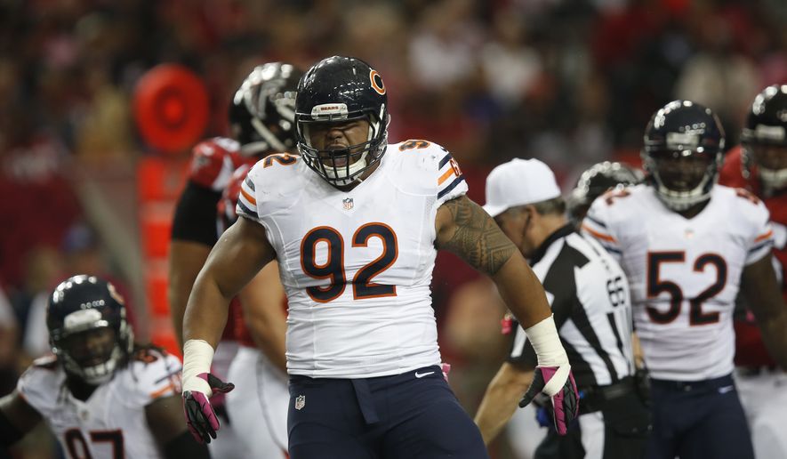 Chicago Bears defensive tackle Stephen Paea (92) reacts to a helping sack Atlanta Falcons quarterback Matt Ryan (2) during the first half of an NFL football game, Sunday, Oct. 12, 2014, in Atlanta. (AP Photo/Brynn Anderson )