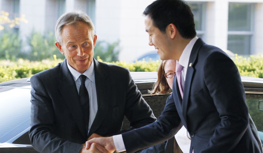 Deputy Chief of Protocol Dennis Cheng (right) greets former British Prime Minister and Quartet Representative Tony Blair upon arrival at the State Department in Washington for a meeting with Secretary of State Hillary Rodham Clinton on Aug. 31, 2010. (Associated Press)