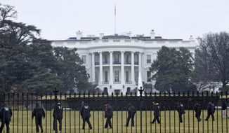 In this Jan. 26, 2015, file photo, Secret Service officers search the south grounds of the White House in Washington after an unmanned aerial drone was found on the White House grounds during the middle of the night. (AP Photo/Susan Walsh, File)