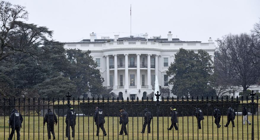 In this Jan. 26, 2015, file photo, Secret Service officers search the south grounds of the White House in Washington after an unmanned aerial drone was found on the White House grounds during the middle of the night. (AP Photo/Susan Walsh, File)