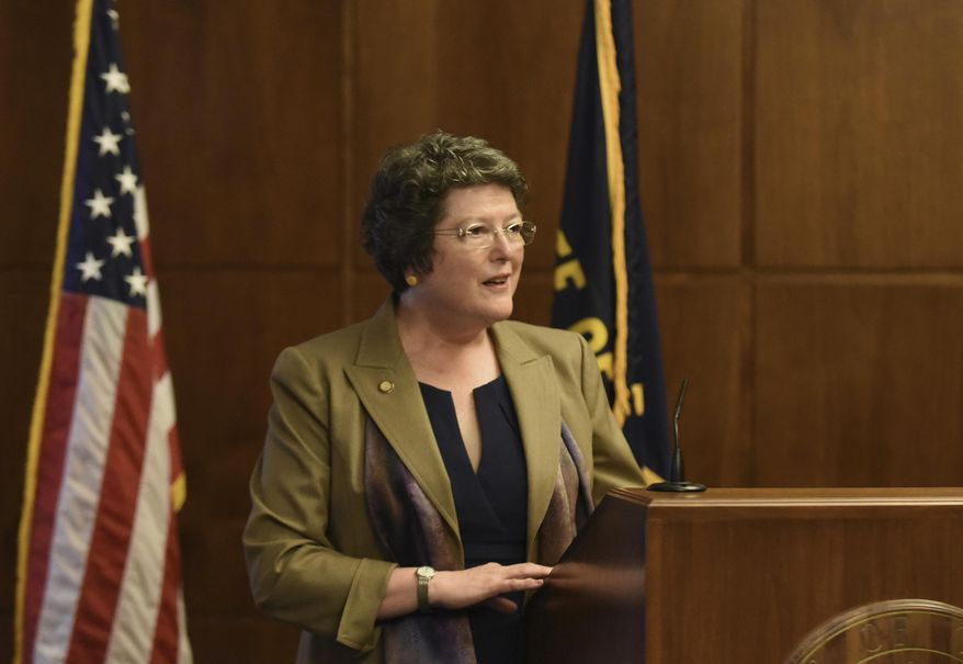 Jeanne P. Atkins speaks to the media after being sworn in as Oregon Secretary of State during a ceremony on Wednesday, March 11, 2015, at the Oregon State Capitol in Salem, Ore. (AP Photo/Statesman-Journal, Danielle Peterson)