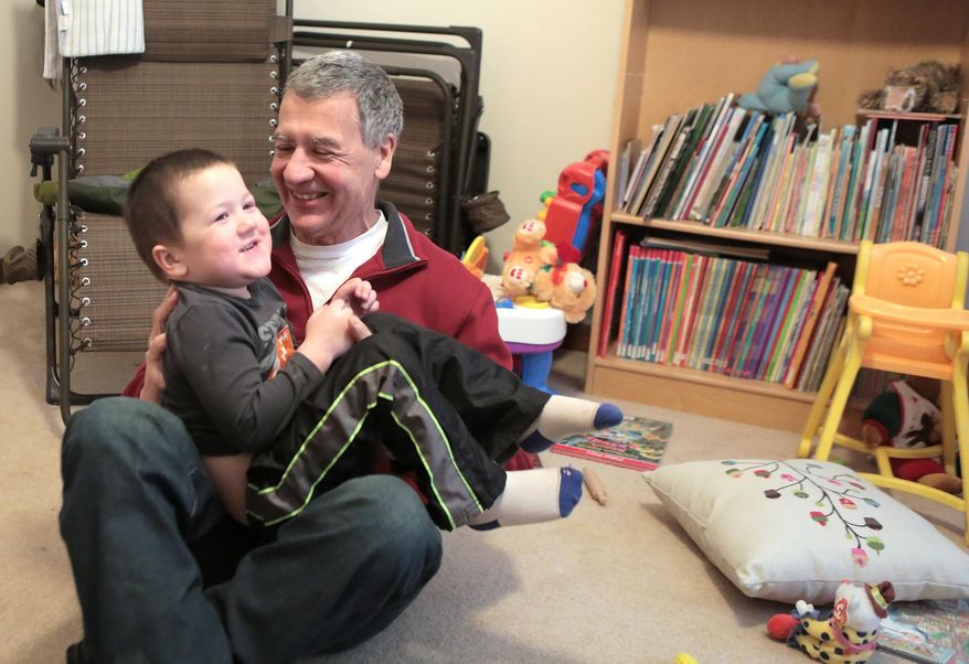 In this Feb. 25, 2015 photo, John Unterfranz plays with his grandson Jackson St. Germain, 3, at Unterfranz's home in Crown Point, Ind. Unterfranz was diagnosed with early-onset Alzheimer’s last November. More than 28 million baby boomers will develop Alzheimer's in their lifetimes, experts predicted in a new analysis. (AP Photo/The Times, Jonathan Miano) MANDATORY CREDIT; CHICAGO LOCALS OUT; GARY OUT **FILE**