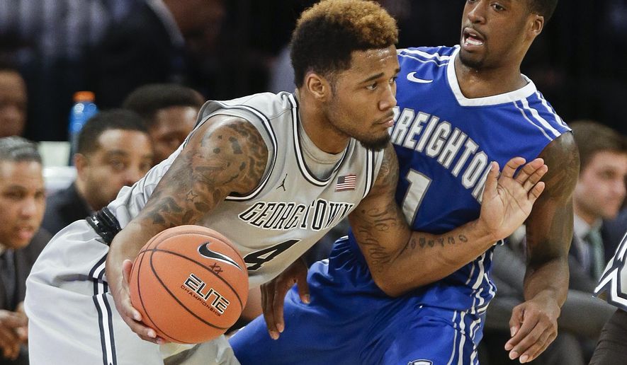 Georgetown&#39;s D&#39;Vauntes Smith-Rivera (4) protects the ball from Creighton&#39;s Austin Chatman (1) during the second half of an NCAA college basketball game in the in the quarterfinals of the Big East Conference tournament, Thursday, March 12, 2015, in New York. Georgetown won the game 60-55. (AP Photo/Frank Franklin II)