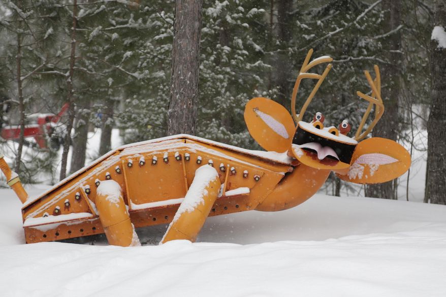 This Feb. 7, 2015 photo shows the sculpture park that is owned by Tom Lakenen in Chocolay Township, Mich. Lakenen is the founder and owner of Lakenenland, a drive-through sculpture park in the Upper Peninsula woods just east of Marquette. The park's 37 acres are populated by dozens of large iron figures of pigs and dragons, flying saucers and sunflowers, mermaids and pink elephants, all standing at various intervals alongside a winding road. The park is always open, always free of charge. (AP Photo/Detroit Free Press, Mandi Wright) DETROIT NEWS OUT; TV OUT; MAGS OUT; NO SALES; MANDATORY CREDIT DETROIT FREE PRESS
