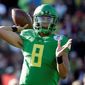 Oregon quarterback Marcus Mariota will be taken fifth in the NFL draft by the Redskins, if he falls to them, according to ESPN reporter John Clayton in a recent radio interview. (Associated Press)