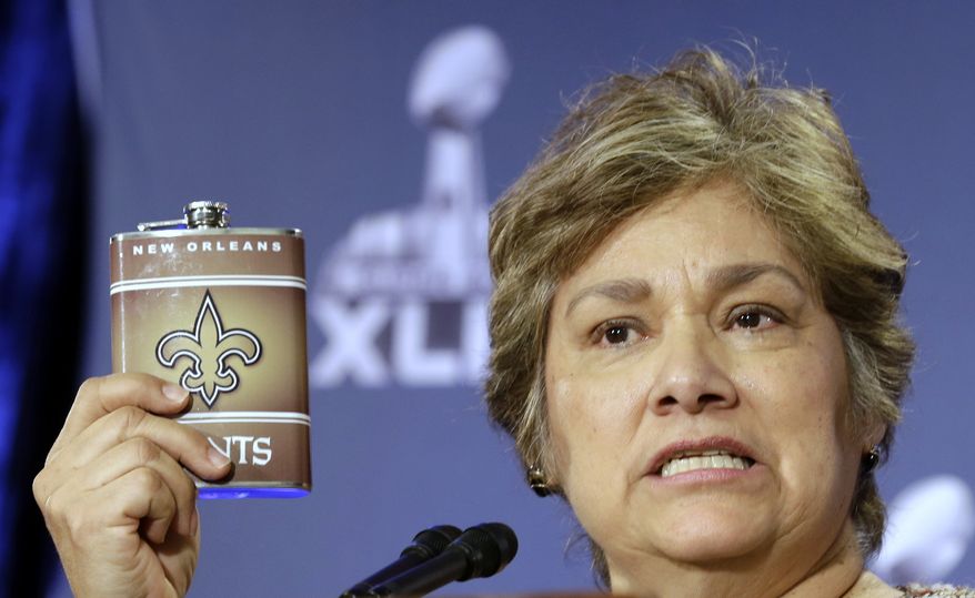 FILE - In this Jan. 29, 2015, file photo, U.S. Immigration and Customs Enforcement Director Sarah Saldana holds up a counterfeit flask during a counterfeit ticket and merchandise news conference for NFL Super Bowl XLIX football game in Phoenix. Federal agents in a sweep targeting the most dangerous criminal immigrants arrested 15 people who have been allowed to remain in the U.S. under President Barack Obama's executive action intended to protect children who came to the U.S. years ago with their parents, The Associated Press has learned. Saldana said the operation focused on "the worst of the worst criminals." (AP Photo/Morry Gash, File)