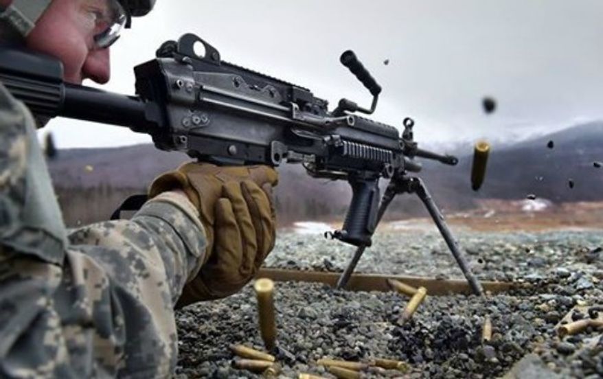A soldier fires his Squad Automatic Weapon during training in Alaska. (Image: U.S. Army, Twitter) ** FILE **