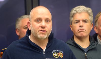 Noel DiGerolamo, left, president of the Suffolk County Police Benevolent Association, and Suffolk County Executive Steven Bellone, speak with reporters at a news conference at Stony Brook University Hospital, Thursday, March 12, 2015, in Stony Brook, N.Y. (AP Photo/Mike Balsamo)