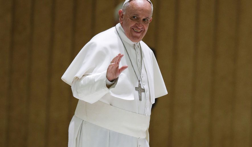 Pope Francis waves to faithful as he arrives on the occasion of an audience with participants to the course promoted by the Penitentiary Apostolic Tribunal, in the Paul VI hall at the Vatican,  Thursday, March 12, 2015. (AP Photo/Andrew Medichini)