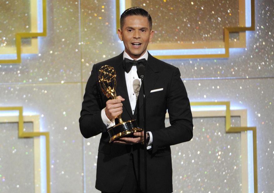 In this June 22, 2014 file photo, Rodner Figueroa accepts the award for outstanding daytime talent in Spanish for “El Gordo y la Flaca” at the 41st annual Daytime Emmy Awards in Beverly Hills, Calif. Figueroa was fired from Univision after saying that Michelle Obama looks like someone from the cast of "Planet of the Apes." Figueroa, who’s known for his biting fashion commentary, made his remarks during a live segment of the show "El Gordo y la Flaca" in which the hosts were commenting on a viral video that shows a makeup artist transforming himself into different celebrities, including Michelle Obama. (Photo by Chris Pizzello/Invision/AP, File)
